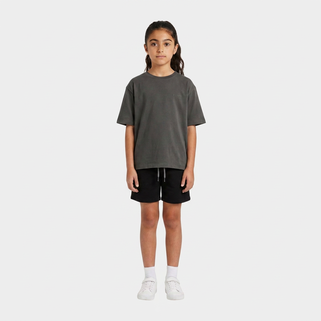 Girl wearing the INSPORT kids Scuba short in black, front view