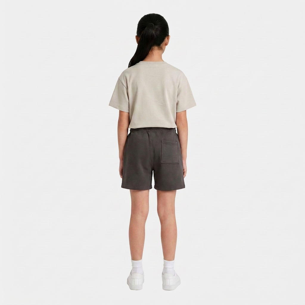 Girl wearing the INSPORT kids Scuba short in charcoal, back view