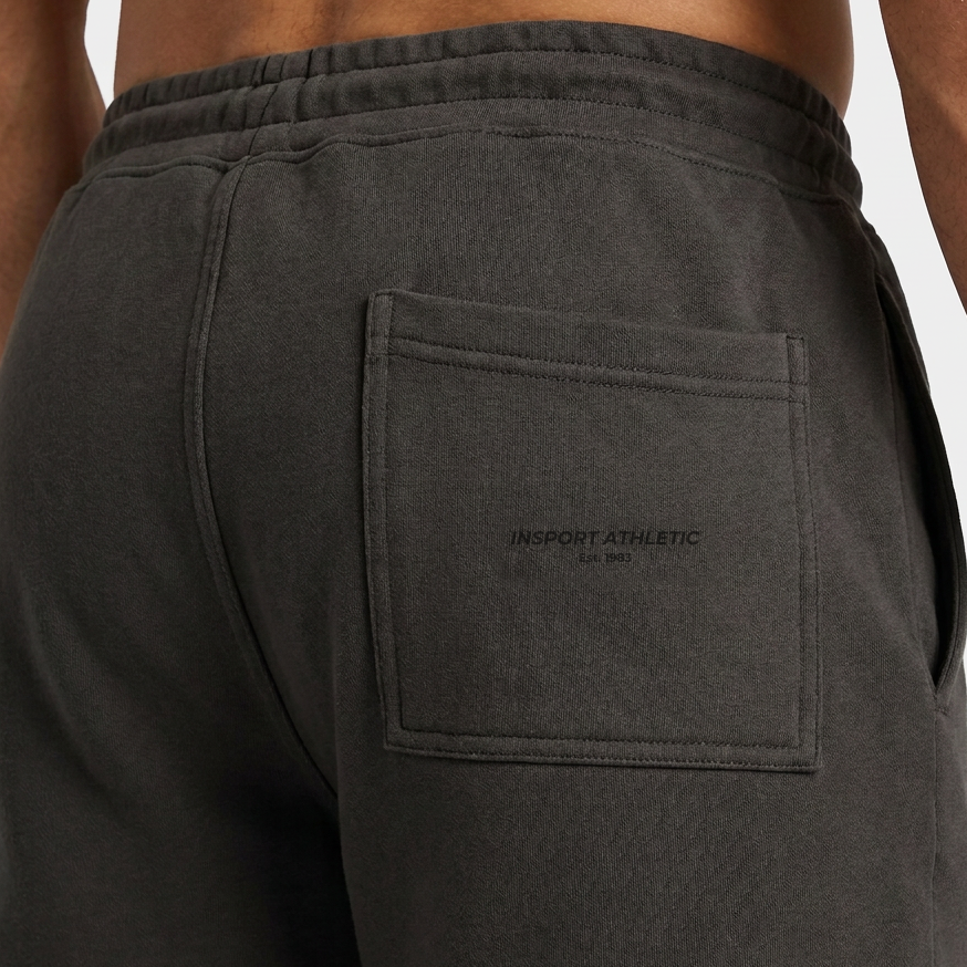 Close-up of the tonal INSPORT Athletic Est. 1983 print on the back pocket of the kids charcoal Scuba short