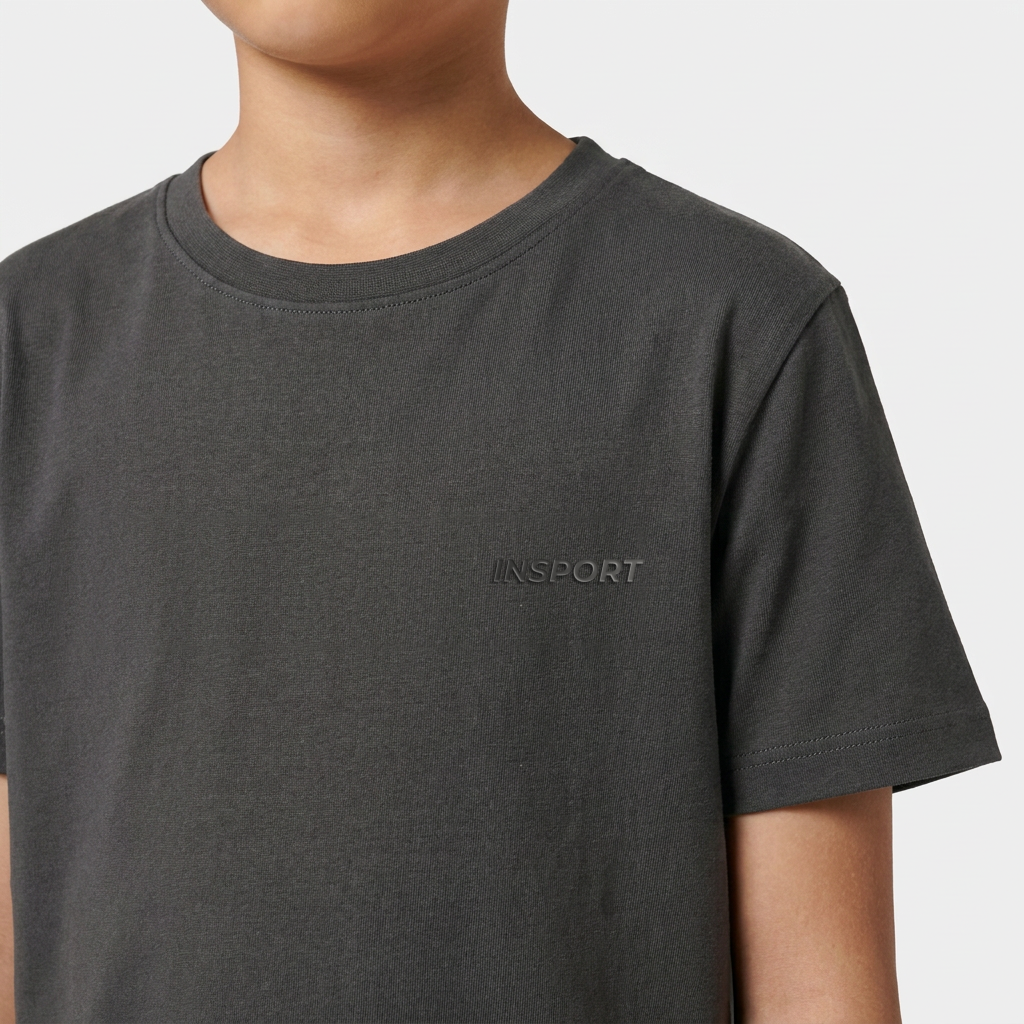 Close-up of the raised rubberised INSPORT chest logo on the kids Scuba tee in charcoal