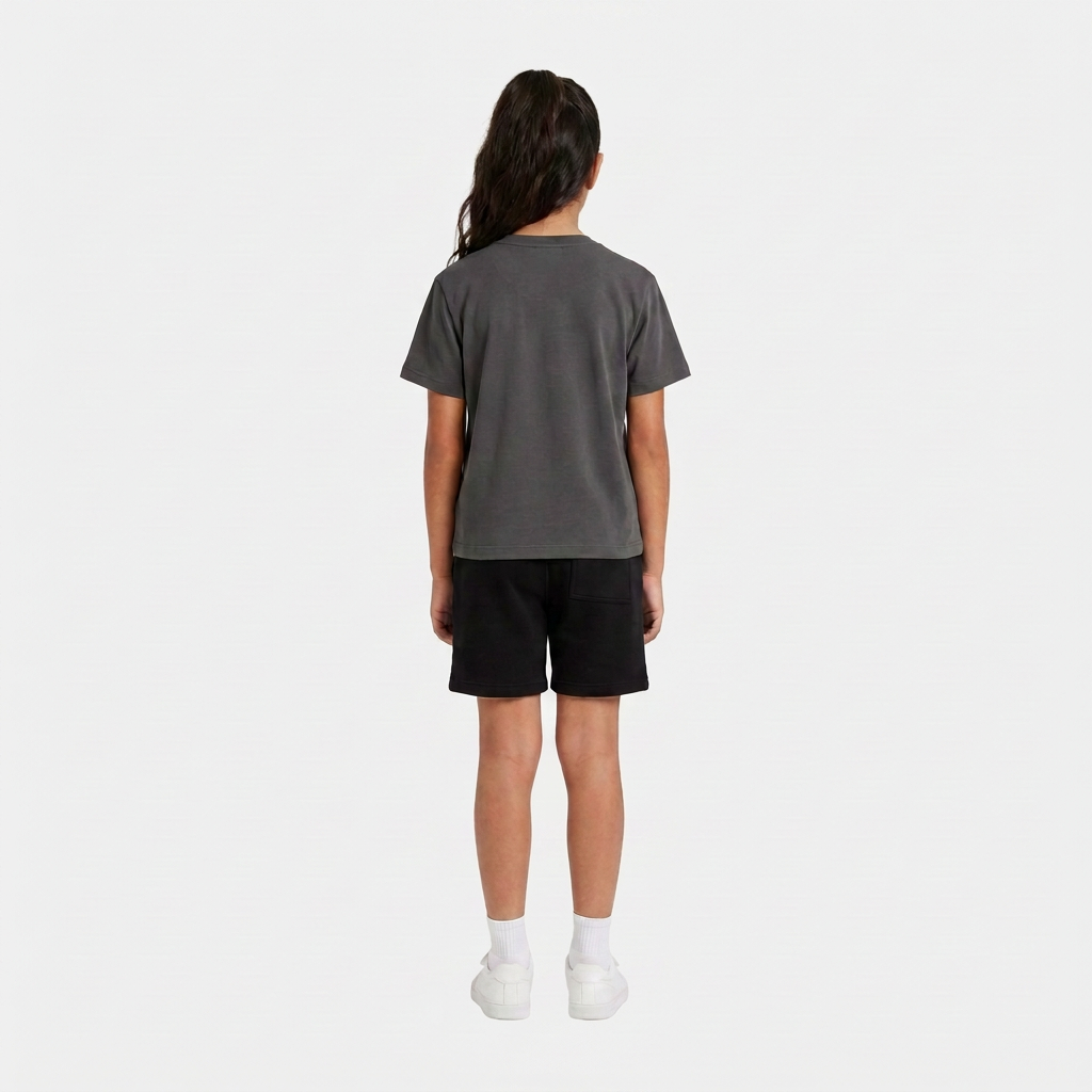 Girl wearing the INSPORT kids Scuba tee in charcoal, back view