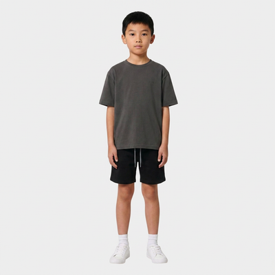 Boy wearing the INSPORT kids Scuba short in black, front view