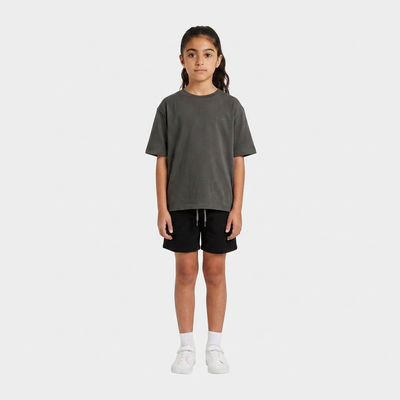 Girl wearing the INSPORT kids Scuba short in black, front view
