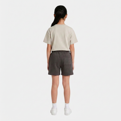Girl wearing the INSPORT kids Scuba short in charcoal, back view