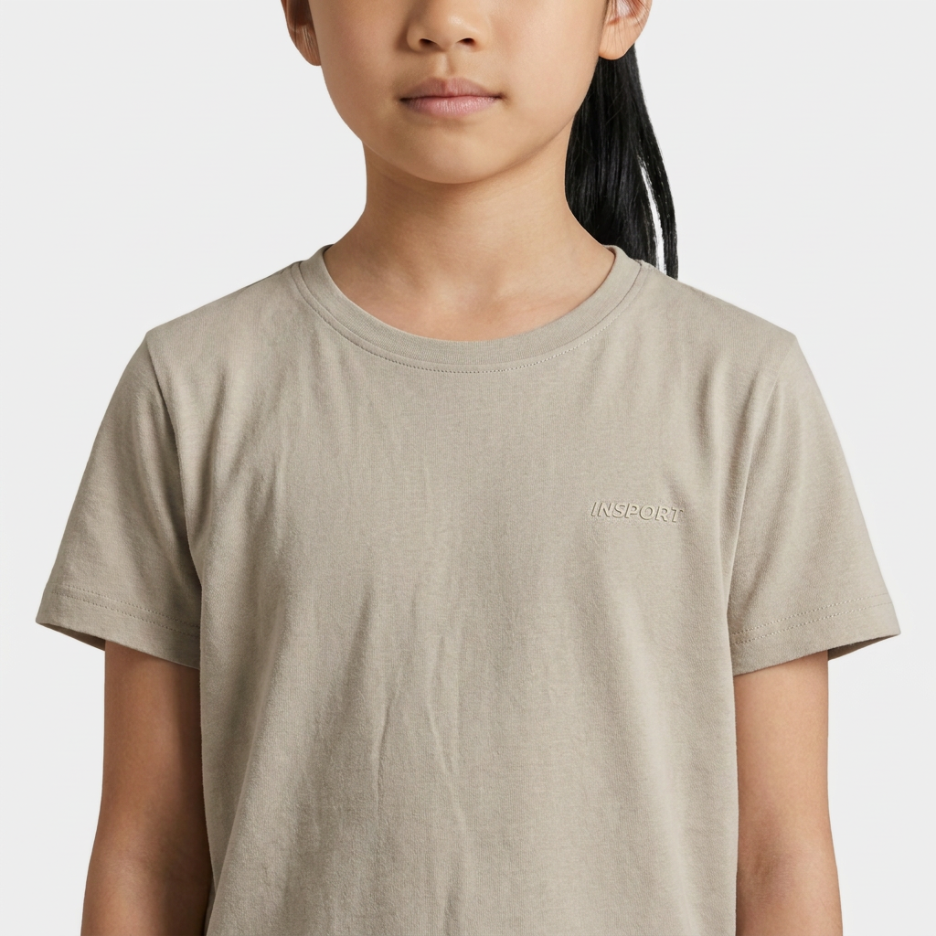 Close-up of the raised rubberised INSPORT chest logo on the kids Scuba tee in stone