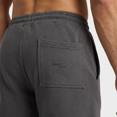 Close-up of the raised INSPORT Athletic Est. 1983 back pocket logo on the charcoal Scuba short