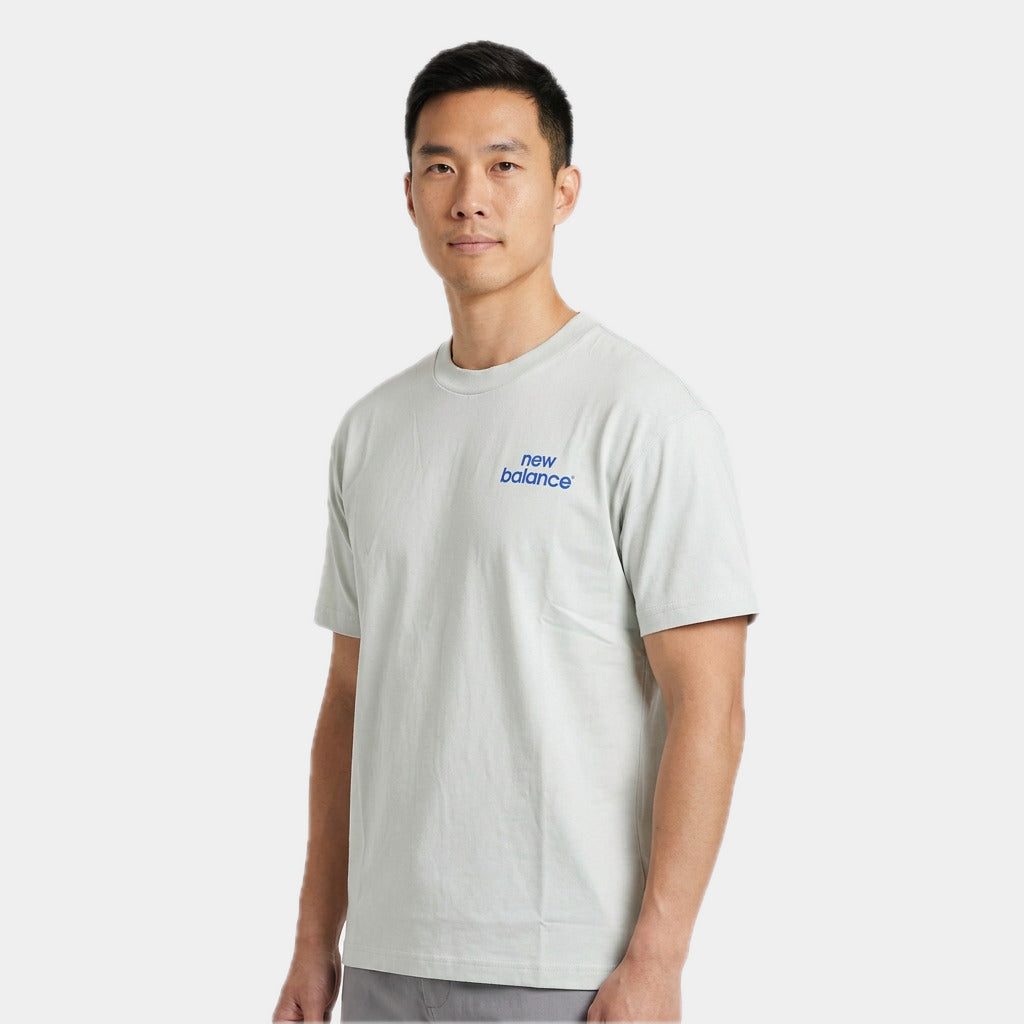 New Balance Men's Intelligent Tee in moss, close view of the chest logo
