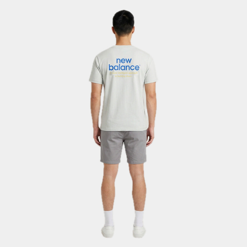 New Balance Men's Intelligent Tee in moss, back view on model showing the back print